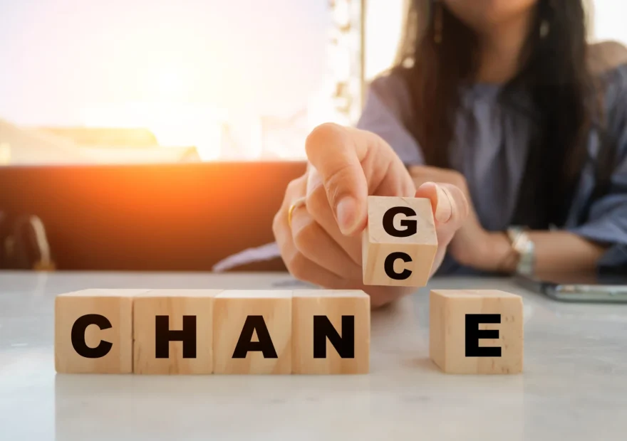 Dłoń obraca drewnianą kostkę, zmieniając napis CHANGE na CHANCE